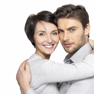 Closeup portrait of  beautiful happy couple isolated on white background. Attractive man and woman being playful.